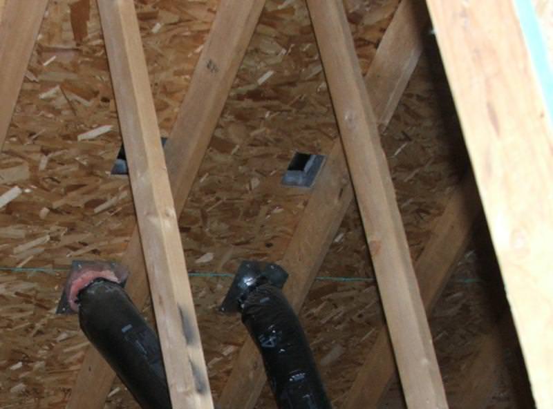 Two vent ducts connected to the bottom of the roof sheathing