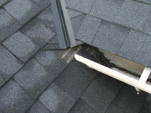 Opened ended gutter draining to roof